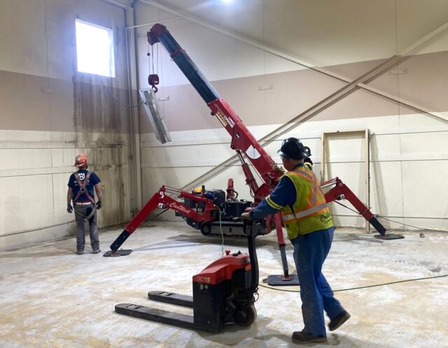 Crane & Picker Services. Mini-Crawler crane being used to remove a wall panel from an enclosed indoor space. 